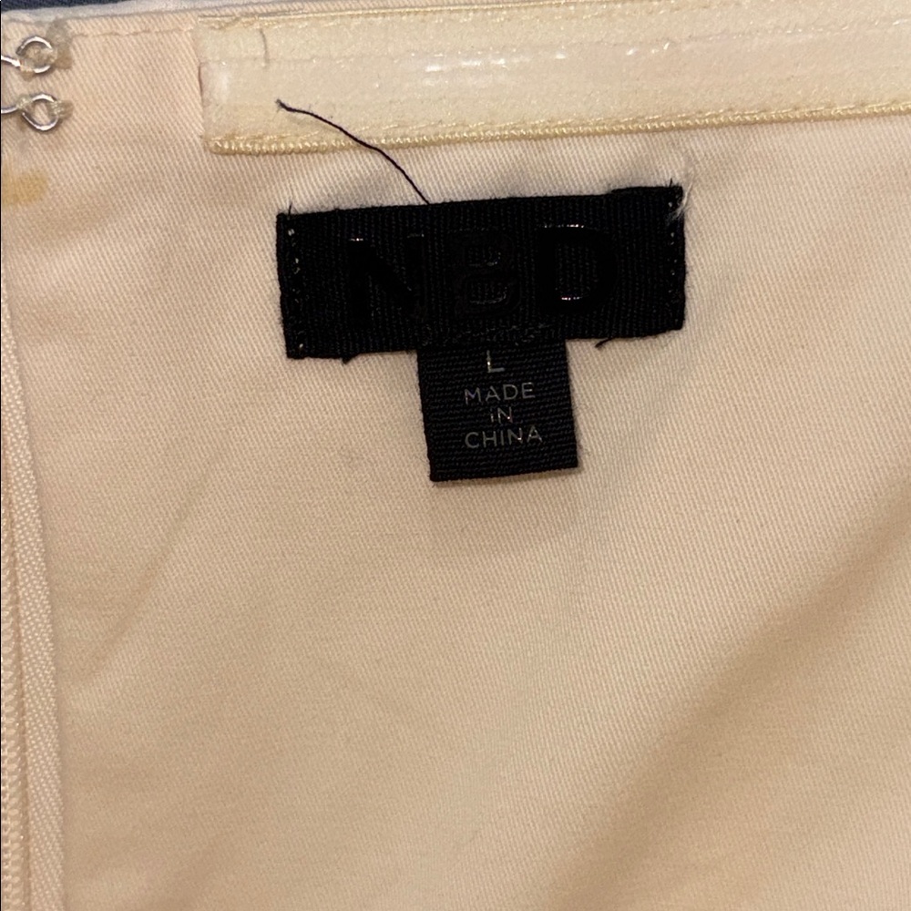 NBD Cream strapless jumpsuit. Double line top,zip back, pockets.size L